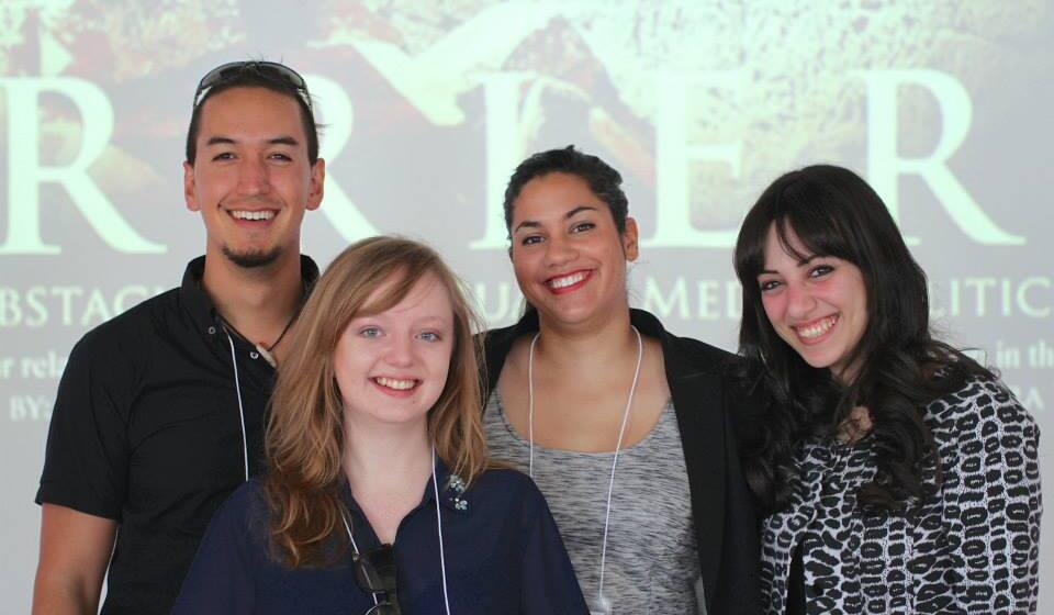four people standing together